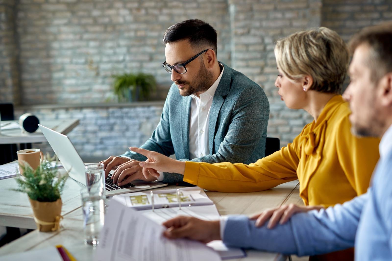 Advisor working through a client's privacy documentation on a laptop
